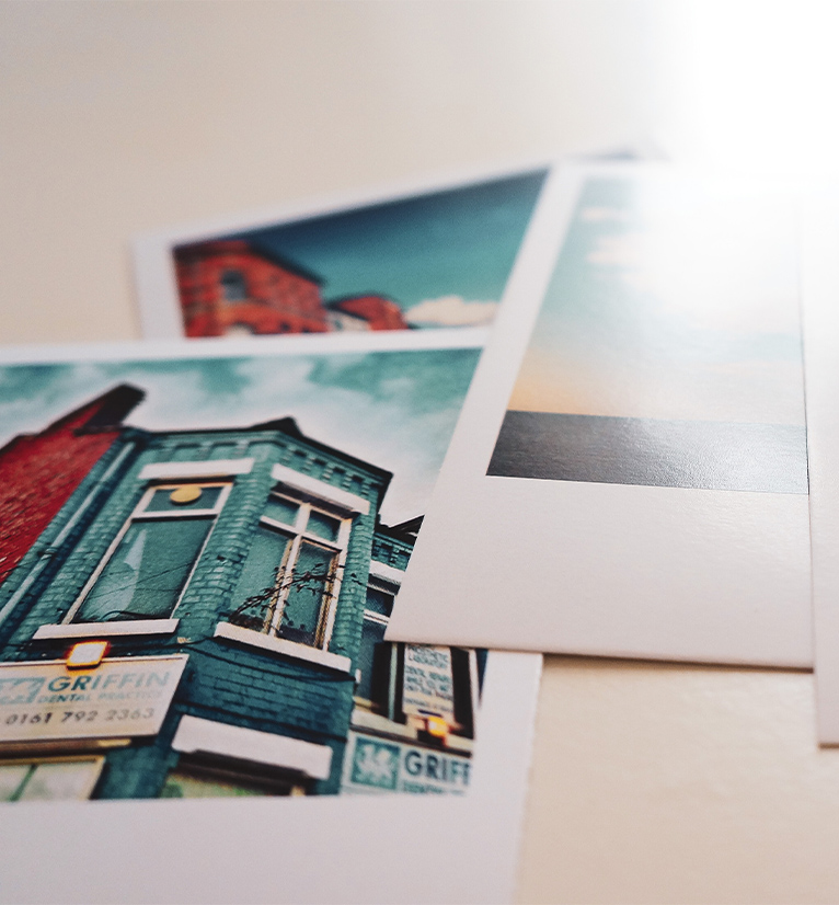 Close up of printed photographs of brick buildings.